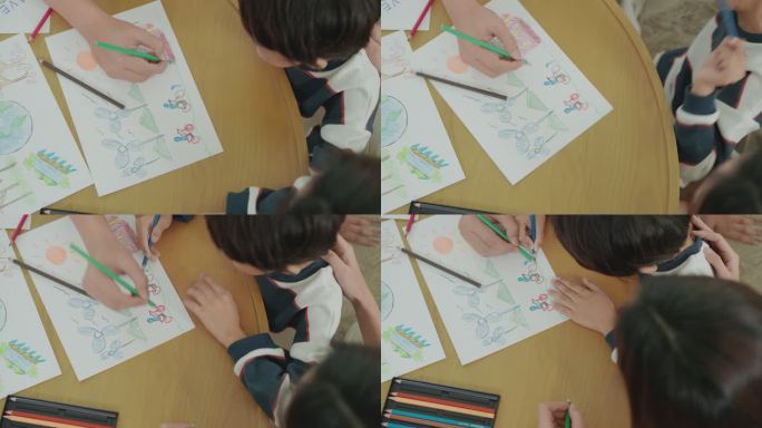 孩子和他的家人的手在纸上享受着色和绘画的俯视图，主题是如何通过绘制如何将能源从燃料转变为风力涡轮机的