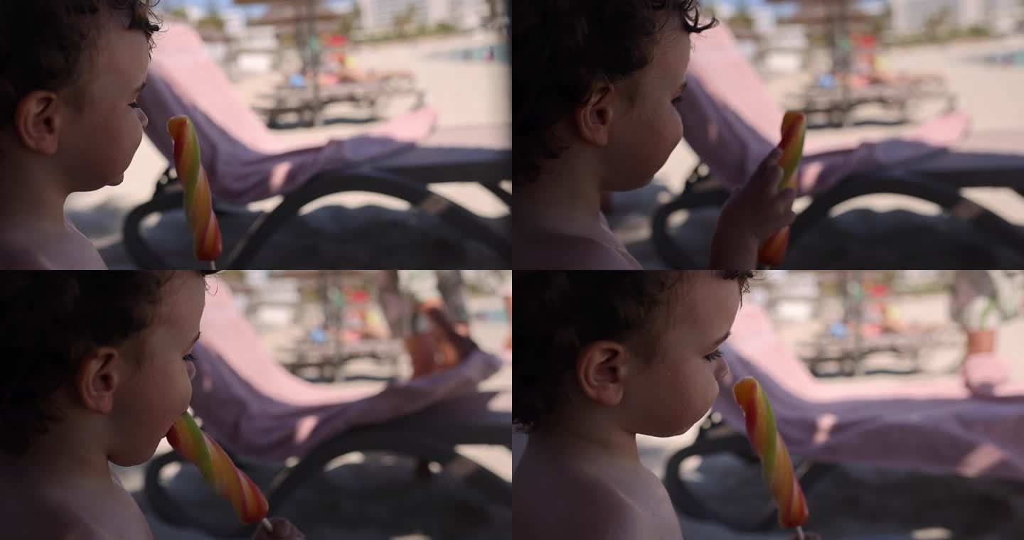海滩上吃冰棍的幼童
