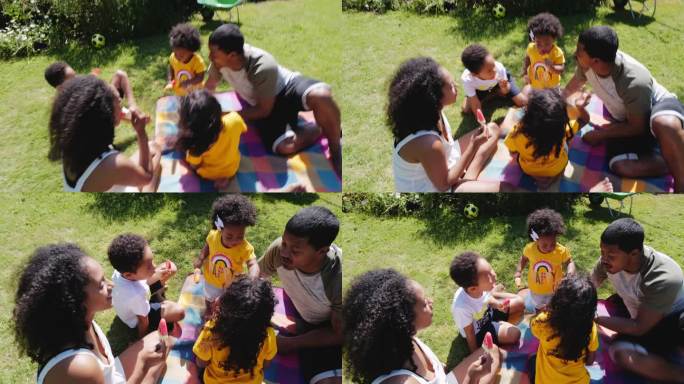 一家人在阳光明媚的夏日庭院里享用西瓜冰棍