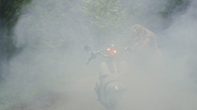 远景：一名女子在森林中摩托车抛锚