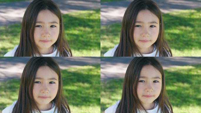 公园里一个快乐的混血亚洲女孩的肖像