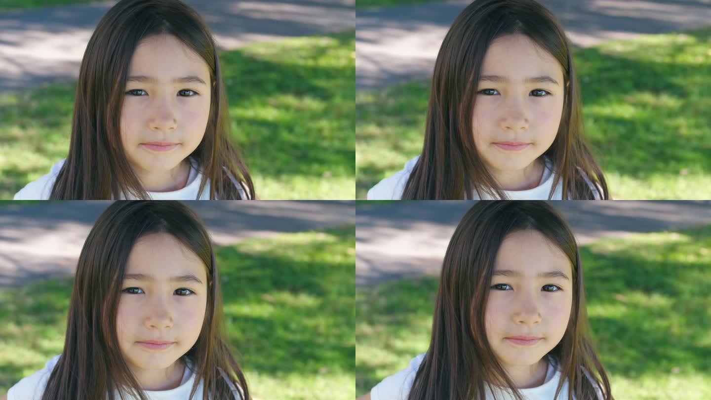 公园里一个快乐的混血亚洲女孩的肖像