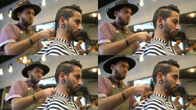 理发师用电动剃须刀为顾客定型