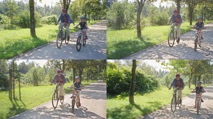 TS男孩和他的爷爷在阳光明媚的公园里骑自行车