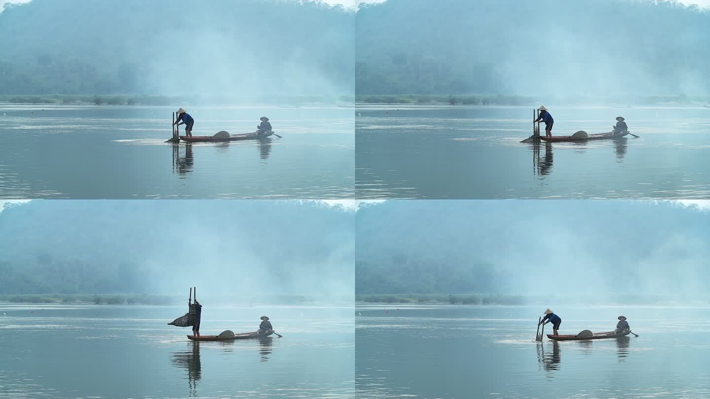 4K：清晨日出前，亚洲渔民在木船上撒网，在自然河中捕捉淡水鱼