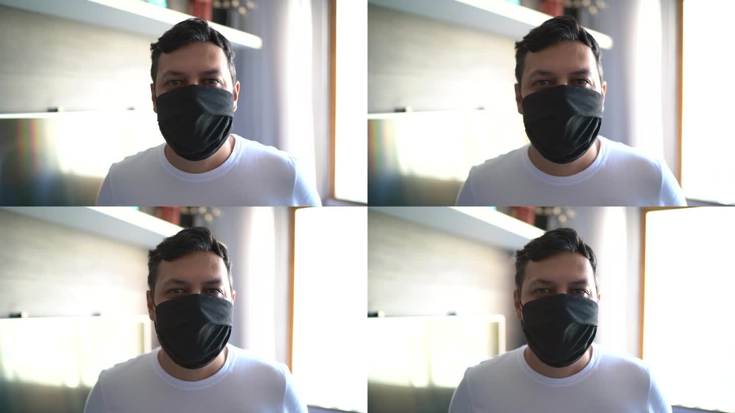 一名男子在家中使用口罩的照片