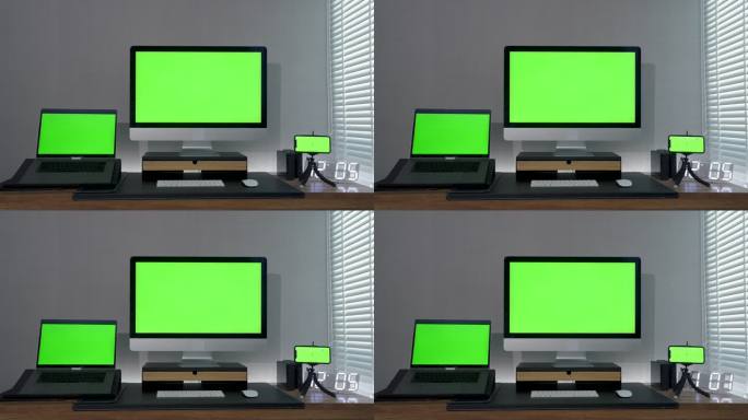 多个显示器在昏暗的房间中显示绿色屏幕。