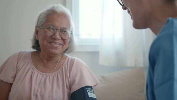 女医生为一位老年患者检查血压。