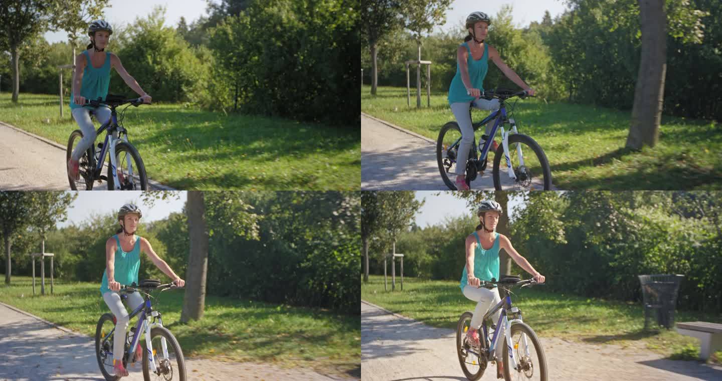 TS女子在阳光明媚的日子骑自行车穿过公园