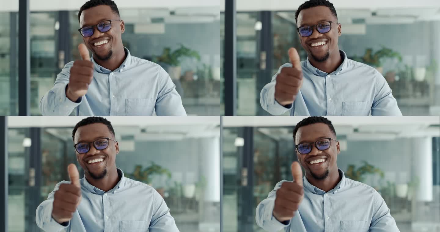 一个快乐而自信的年轻非洲裔美国商人在现代化的办公室里竖起大拇指。一位面带微笑的商人的肖像，露出满意的