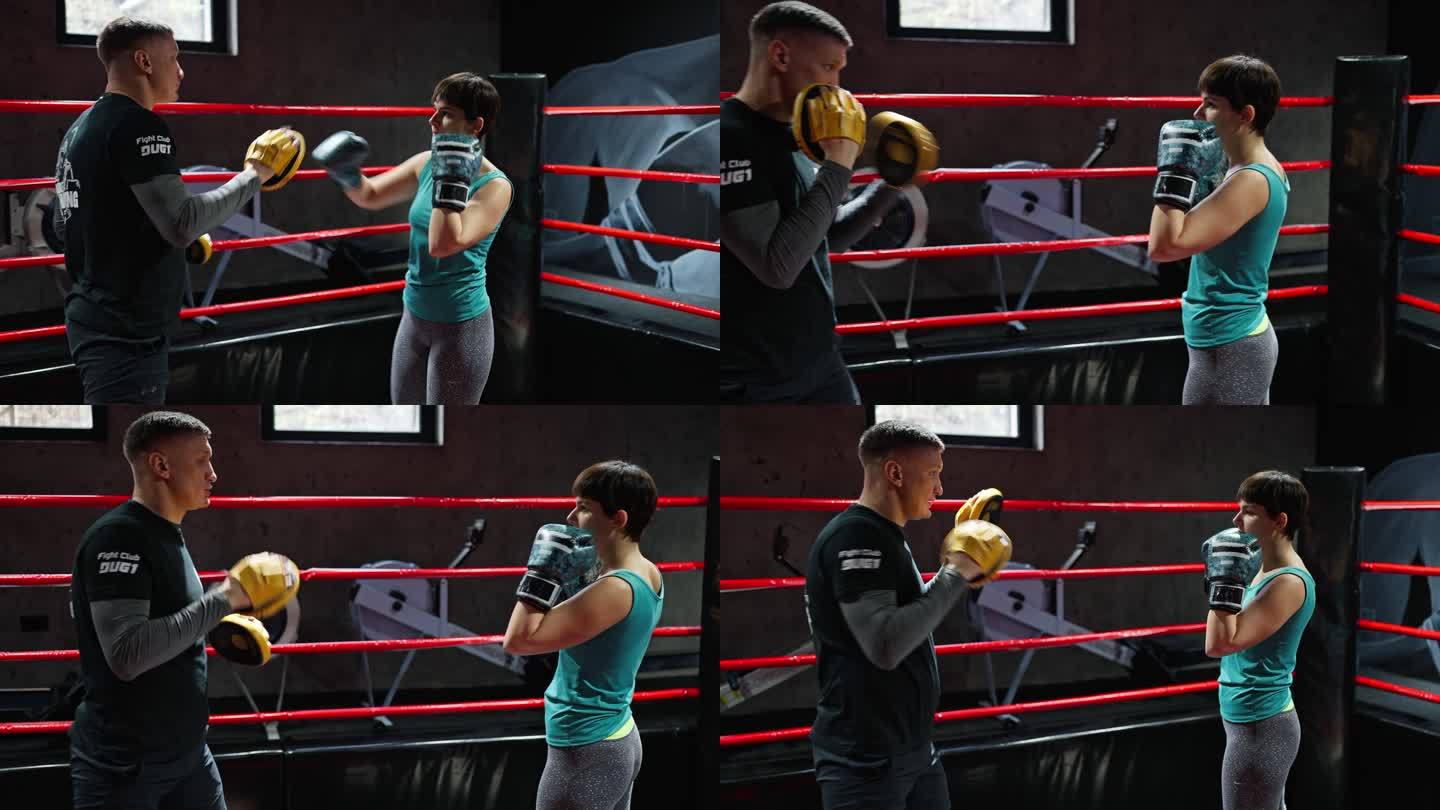 女拳击手与教练一起训练