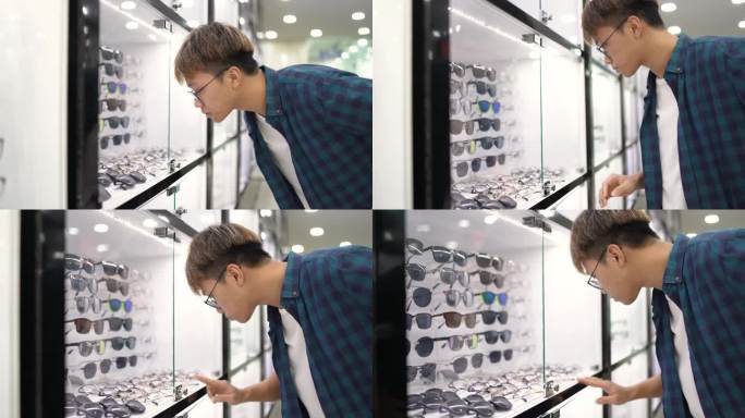 亚洲中国青少年男孩在眼镜店的镜子前试眼镜