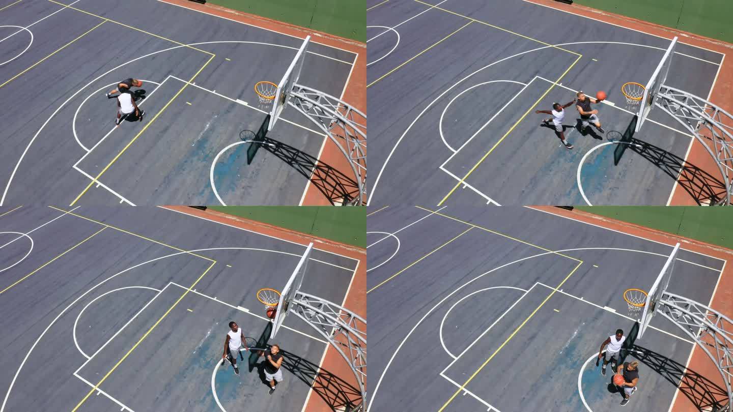 两个面目全非的男子在打篮球时将球射入篮筐。年轻人从上面玩体育