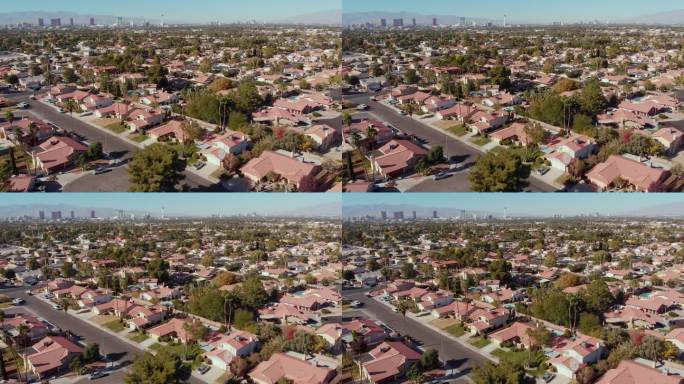 内华达州拉斯维加斯一个开发区的独栋住宅视频剪辑，背景为春季山脉和拉斯维加斯天际线