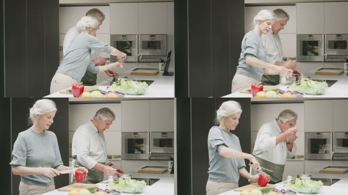 一对老年夫妇在家里的厨房里做饭。一个成熟的男人和女人一起做一顿健康的饭，享受一个放松的退休生活