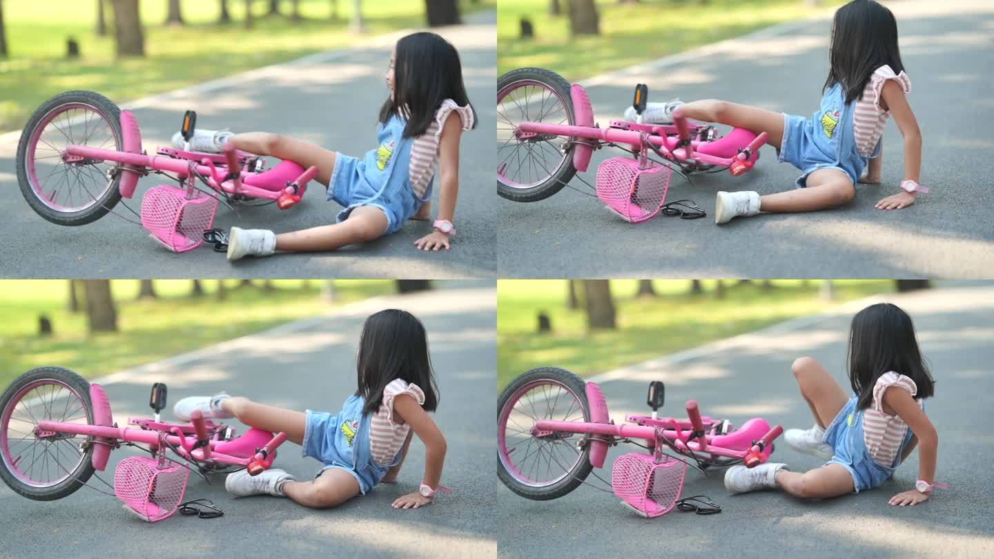 亚洲小女孩在花园里骑自行车
