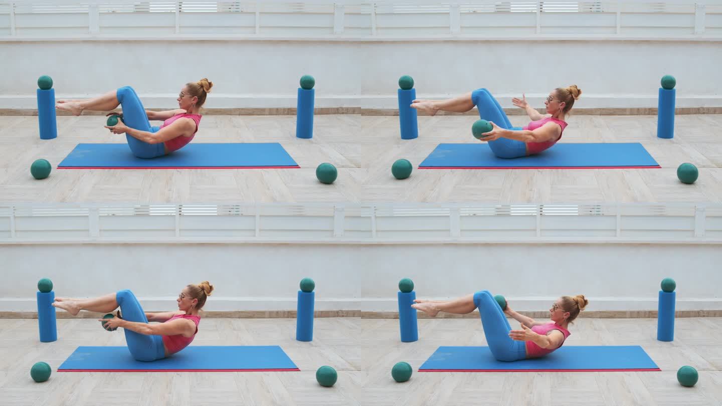 健身女性做腹肌时，双腿膝盖弯曲，在运动垫上一手一手地传递运动球
