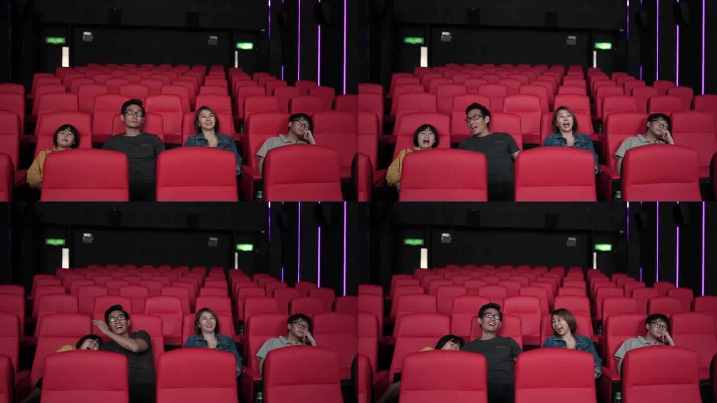 亚洲中国家庭周末在电影院观看恐怖电影。