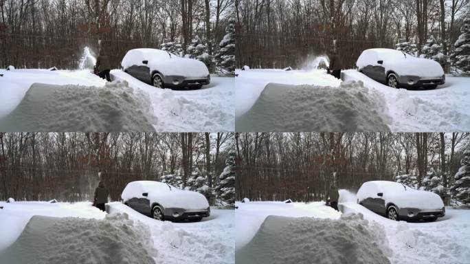 一名男子在冬季暴风雪后清理被雪覆盖的汽车周围的车道。