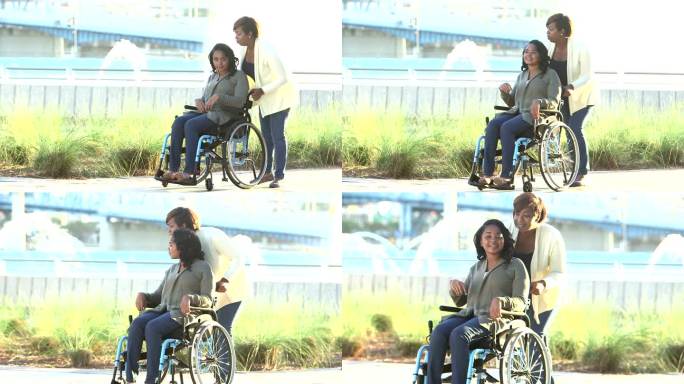 母亲带着十几岁的女儿坐在轮椅上散步