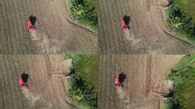 农民使用农业机械耕地的鸟瞰图。