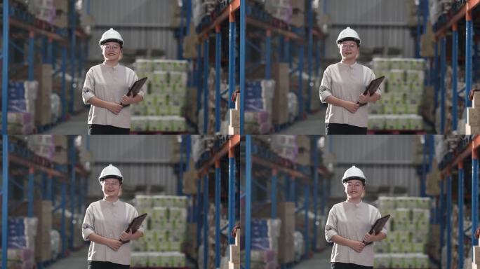 亚洲中国熟女戴着安全帽在仓库里微笑着看着镜头