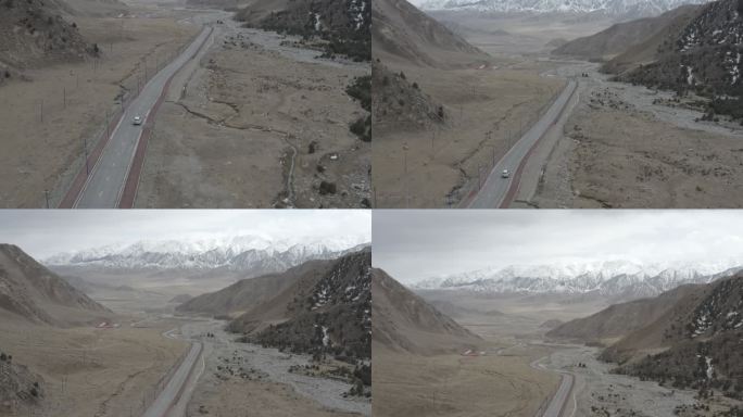 4K航拍 汽车行驶在新疆巍峨雪山