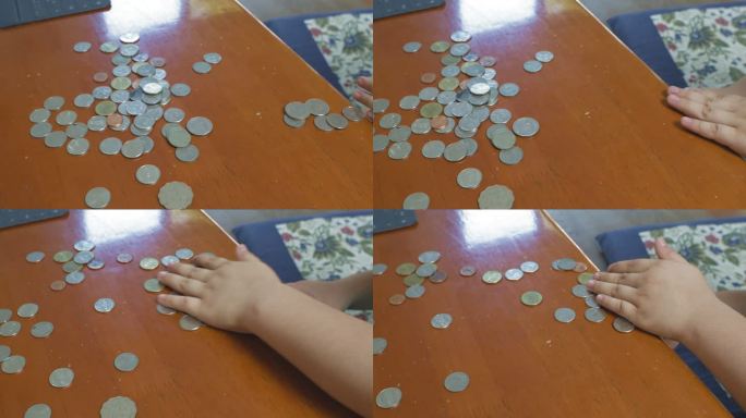 一个小女孩正在锡罐里收集硬币