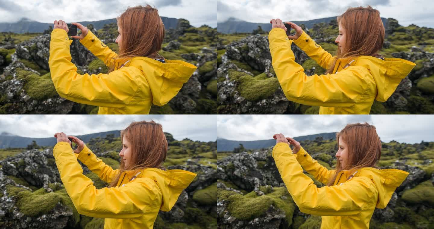 拍摄苔藓覆盖的熔岩石照片的女人
