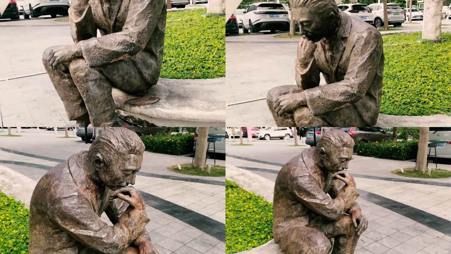 雕塑坐着思考的男人