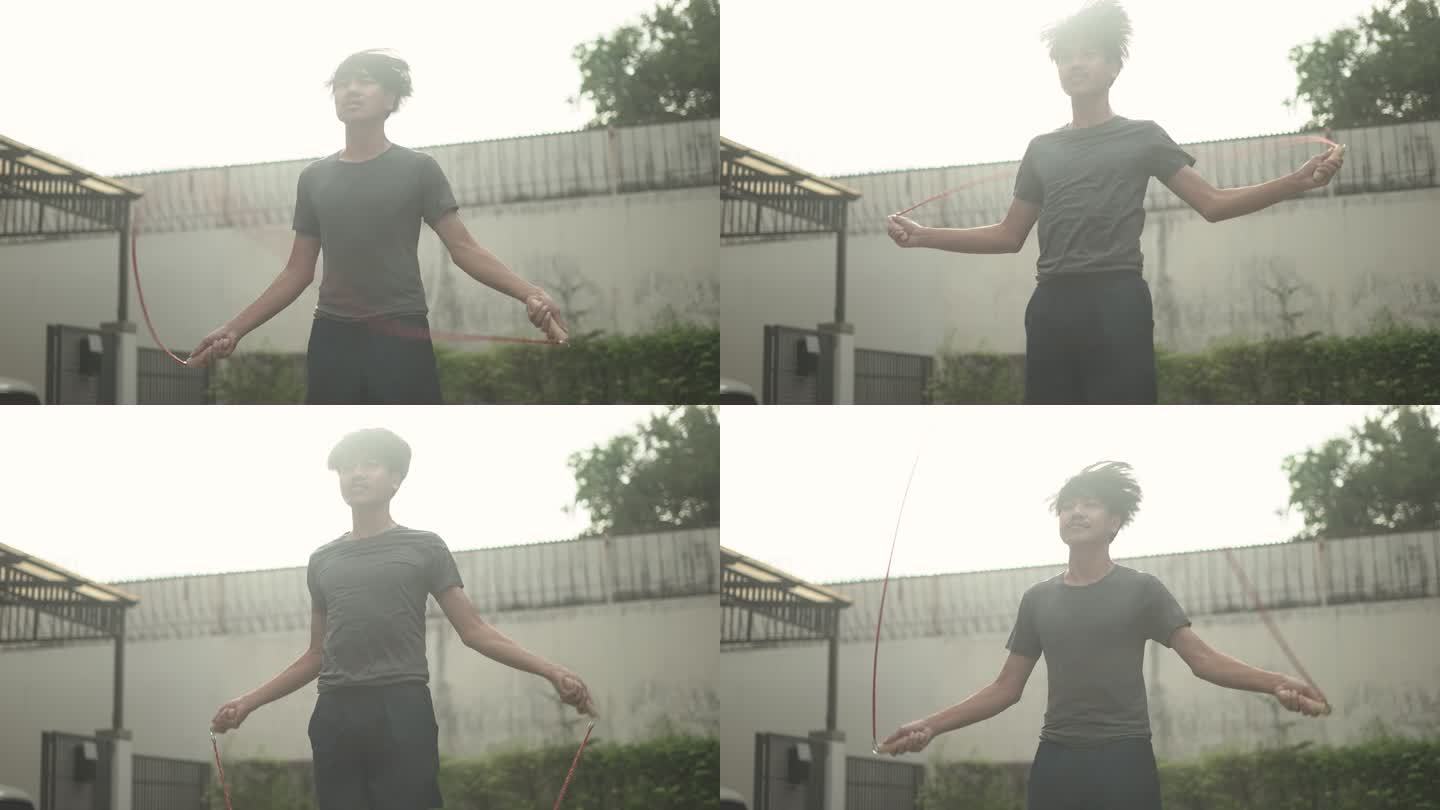 一名亚洲年轻男子凌晨在前院跳绳的慢镜头