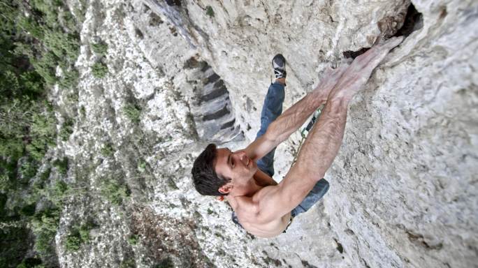SLO MO男登山者在攀登过程中发现了悬崖的抓地力