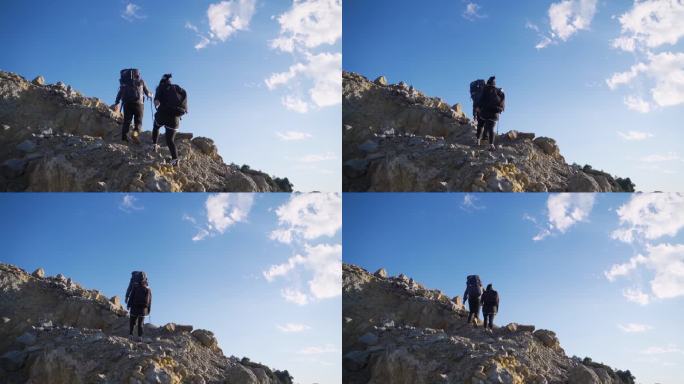 团队爬山背影登山脚步年轻夫妻登山攀登顶峰