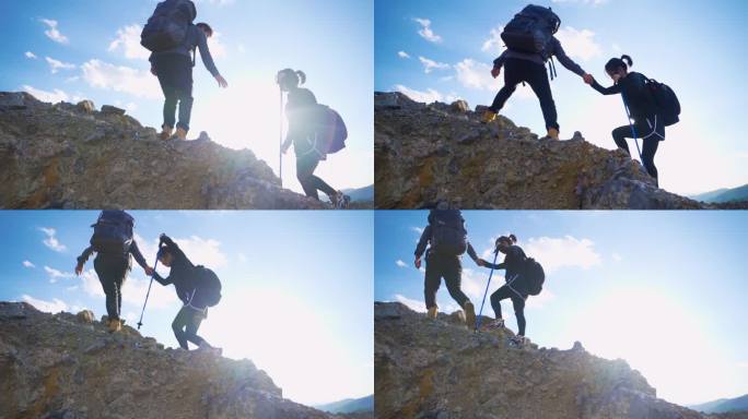 一男一女手拉手登山逆光人物攀登顶峰旅行者