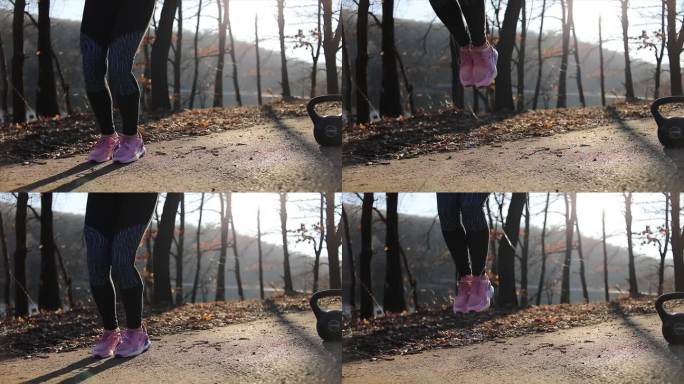 年轻女子跳绳。在春季公园用跳绳进行户外运动的女运动员
