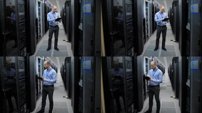 IT工程师在平板电脑的帮助下检查服务器室中的服务器