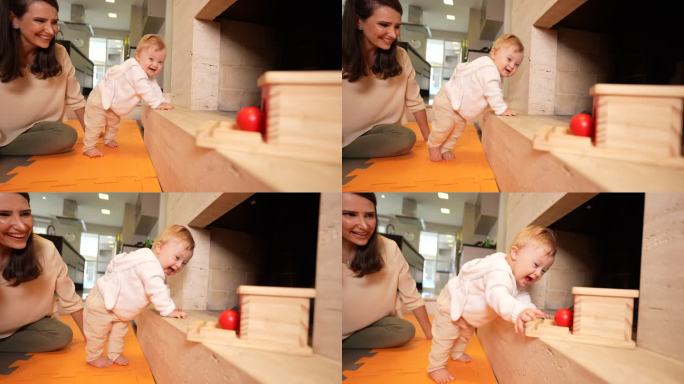 婴儿学习走路靠在家具上拿玩具