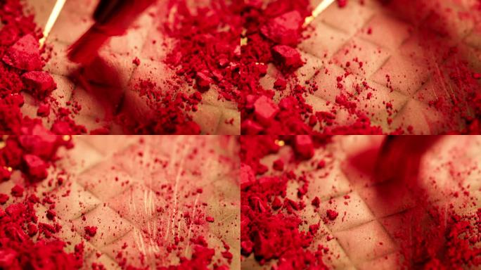 用刷子将红色粉末腮红刷得粉碎。工作室拍摄