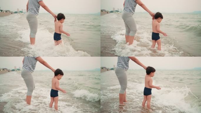 妈妈和小儿子在芭堤雅海滩上一起玩耍。