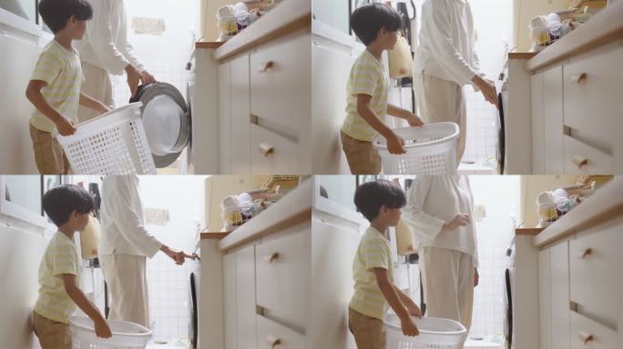 家庭主妇在使用洗衣机时带孩子