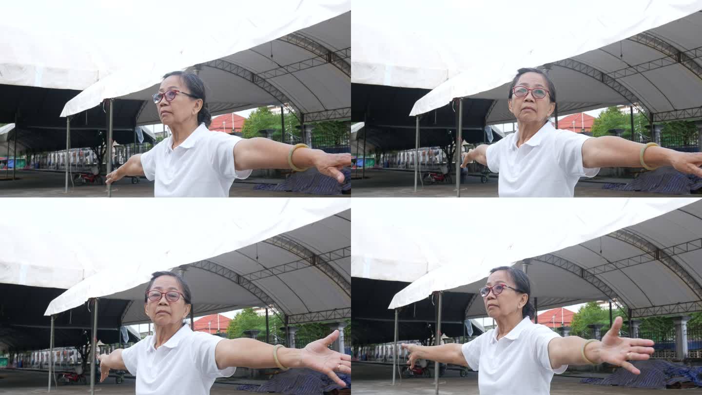 老年妇女在停车场练习太极舞