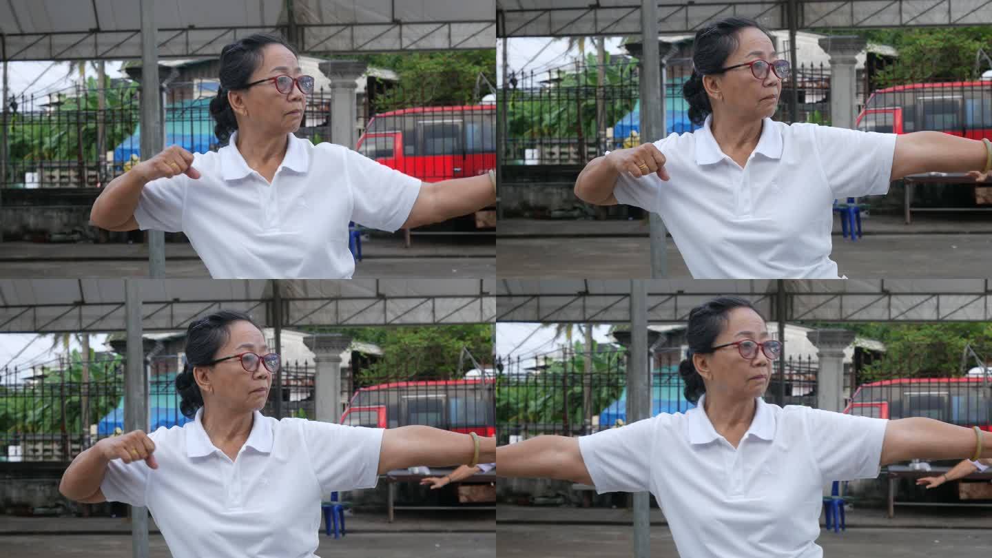 老年妇女在停车场练习太极舞