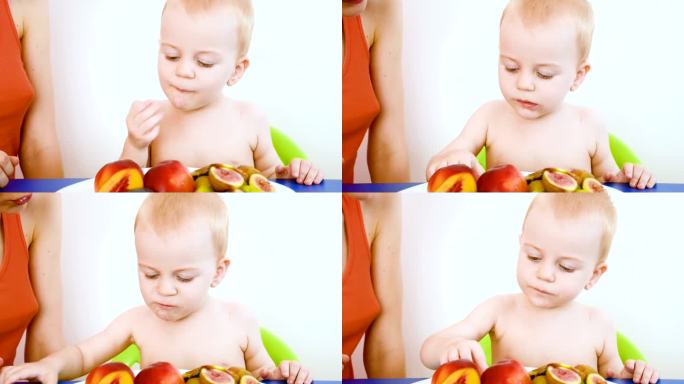 婴儿吃树莓，特写妈妈母亲陪伴孩子婴儿挑选