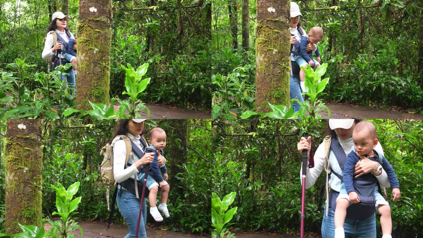 春天的一天，亚洲父母带着孩子在森林里散步