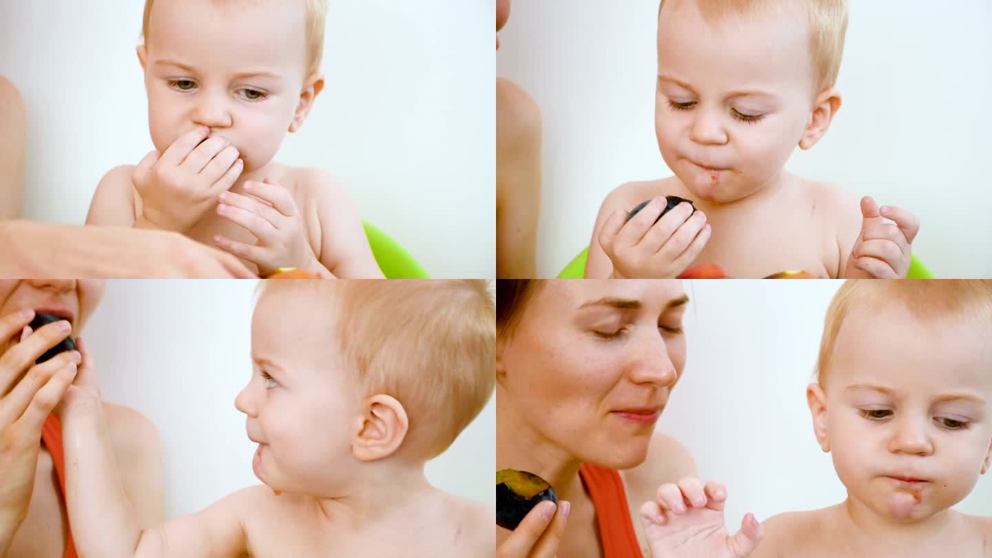 吃李子的小孩妈妈母亲陪伴孩子婴儿挑选水果