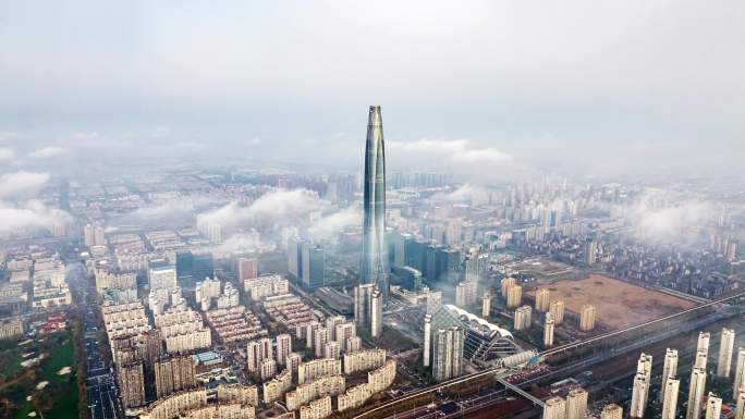 航拍云雾中的天津滨海新区周大福金融中心