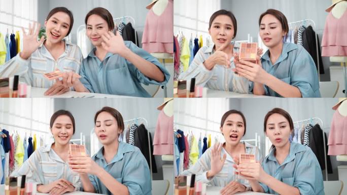 两位美丽的亚洲女性在录制视频和直播流媒体的同时，展示了彩色眼影调色板，通过社交媒体向她们的追随者或客
