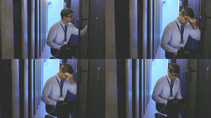 4k视频画面显示，一名年轻男子在服务器室工作时使用笔记本电脑，看起来忧心忡忡