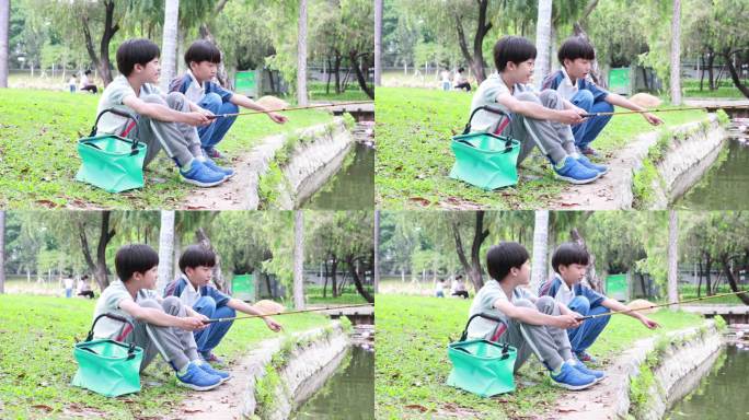 小男孩在湖边钓鱼小男孩公园河边钓鱼上钩童