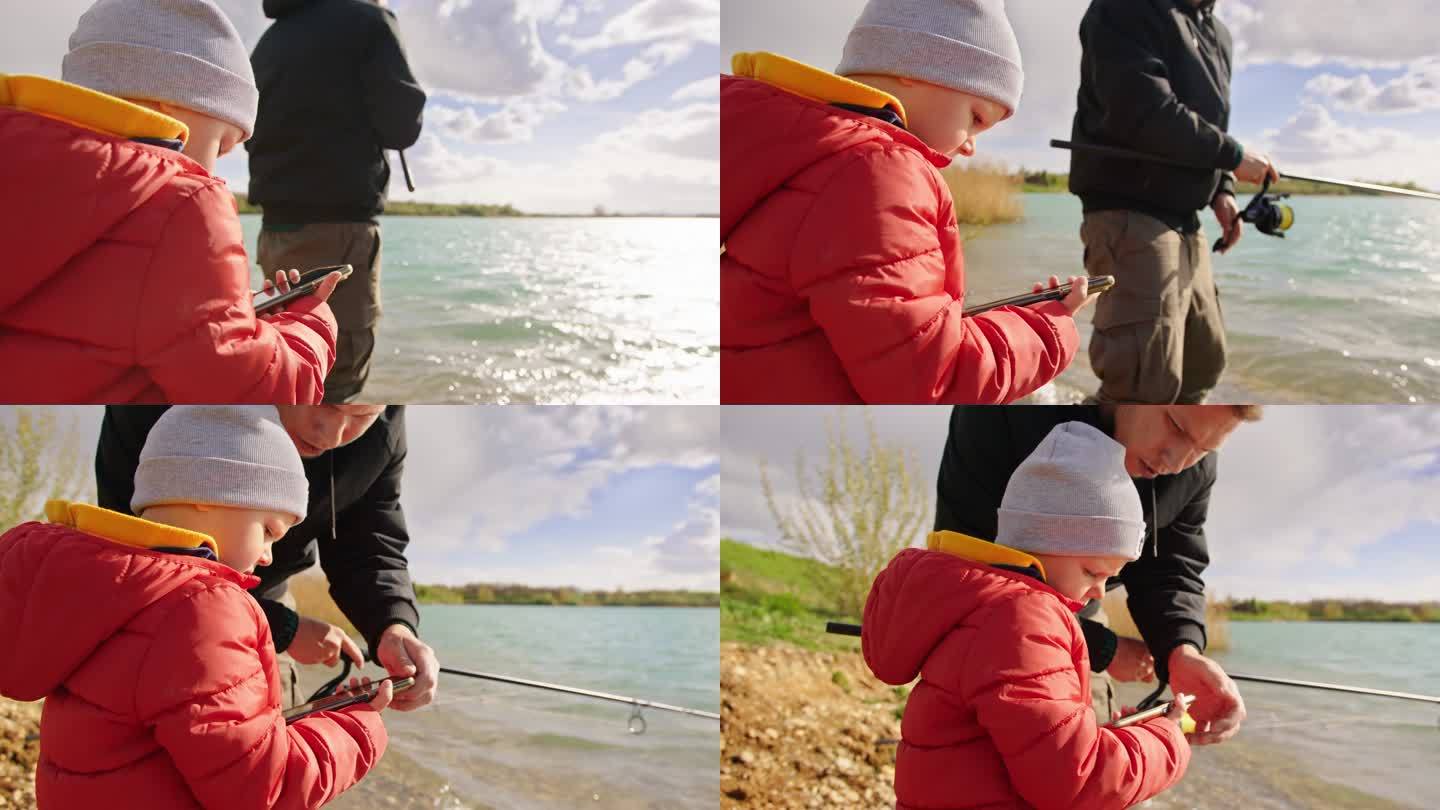 男子和儿子在河上用手机钓鱼